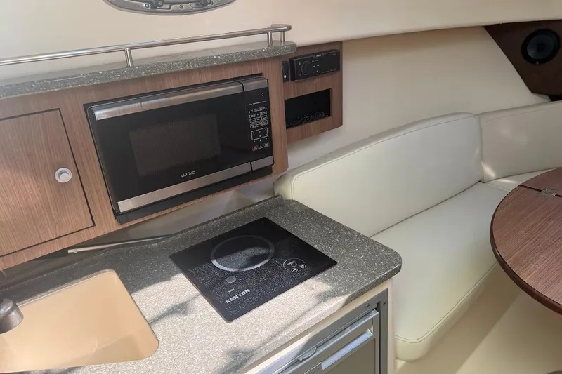 Slide: The Image of Interior of 2017 Boston Whaler 285 Conquest with kitchenette and seating area. - 34