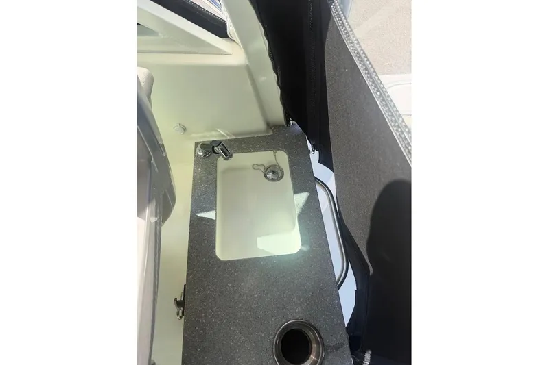 Slide: The Image of 2017 Boston Whaler 285 Conquest boat interior sink and countertop detail. - 48