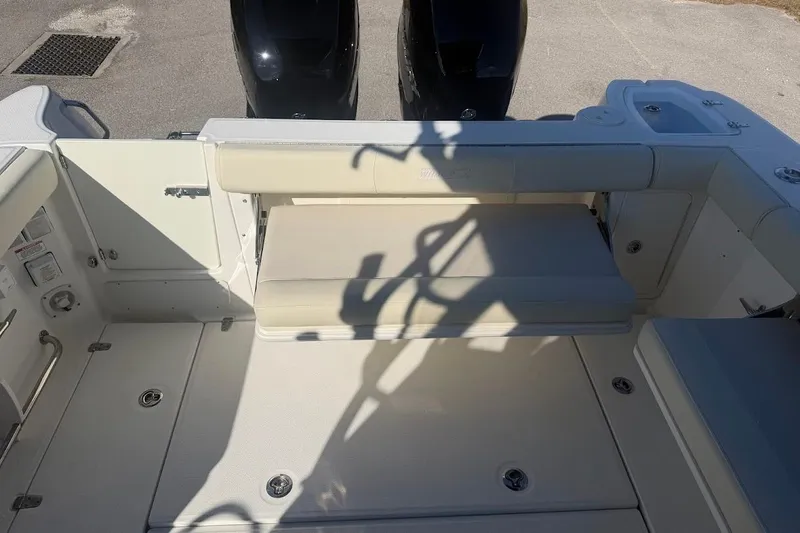 Slide: The Image of 2017 Boston Whaler 285 Conquest boat interior with seating and dual engines. - 50