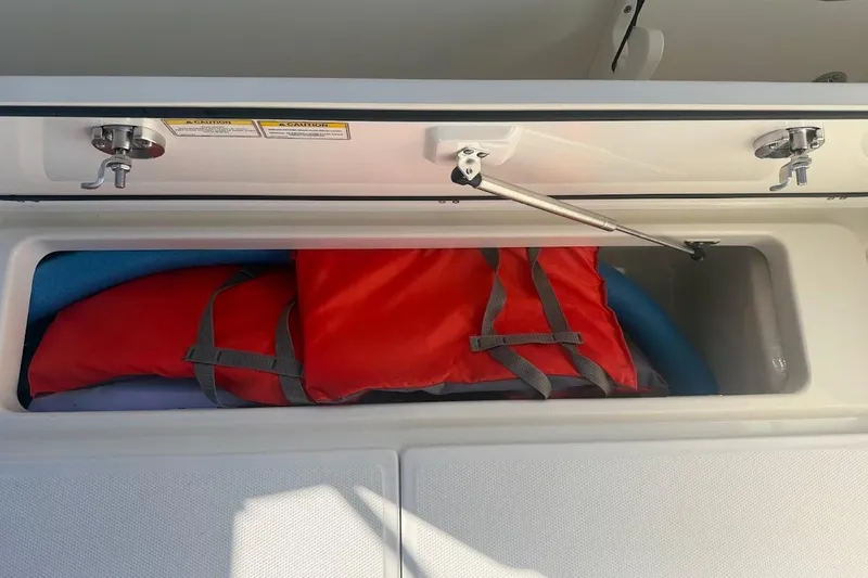 Slide: The Image of Storage compartment with life jackets on a 2017 Boston Whaler 285 Conquest boat. - 53