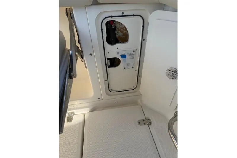 Slide: The Image of 2017 Boston Whaler 285 Conquest interior compartment with access panel and latch. - 54