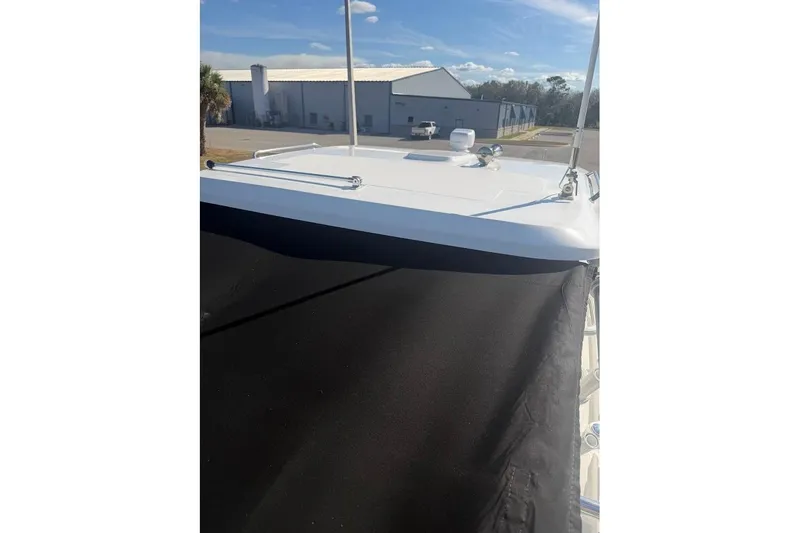 Slide: The Image of 2017 Boston Whaler 285 Conquest boat deck with black cover, outdoor setting. - 55