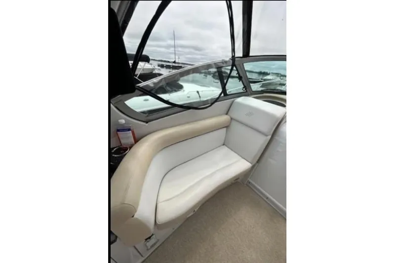 Slide: The Image of 2007 Four Winns 338 Vista boat interior with beige seating and window view. - 10