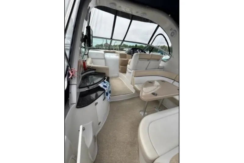 Slide: The Image of 2007 Four Winns 338 Vista boat interior with beige seating and modern amenities. - 12