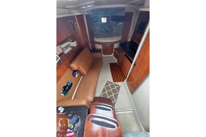 Slide: The Image of 2007 Four Winns 338 Vista cabin interior with brown seating and wood accents. - 13
