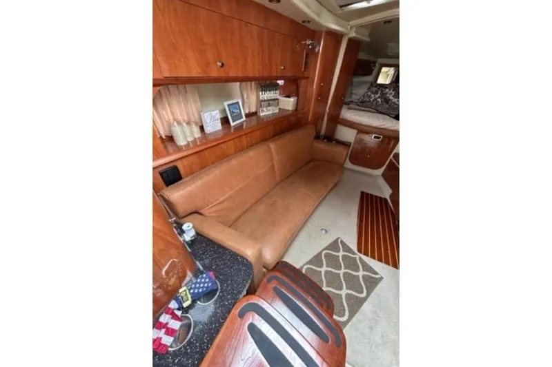 Slide: The Image of Interior of 2007 Four Winns 338 Vista boat with leather seating and wooden cabinetry. - 14