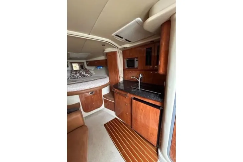 Slide: The Image of 2007 Four Winns 338 Vista cabin interior with kitchenette and sleeping area. - 18