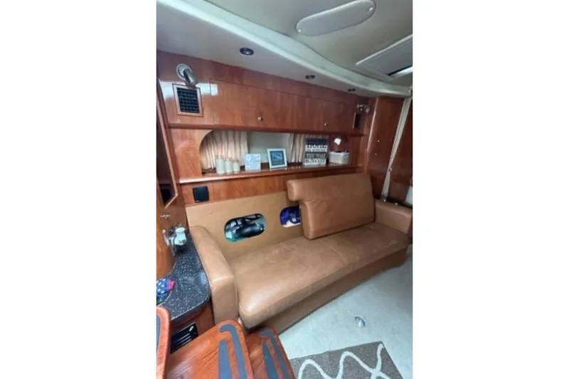 Slide: The Image of Interior of 2007 Four Winns 338 Vista yacht with leather seating and wooden cabinetry. - 19