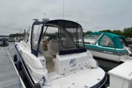 Slide: The Image of 2007 Four Winns 338 Vista boat docked at marina, featuring sleek design and covered seating area. - 3