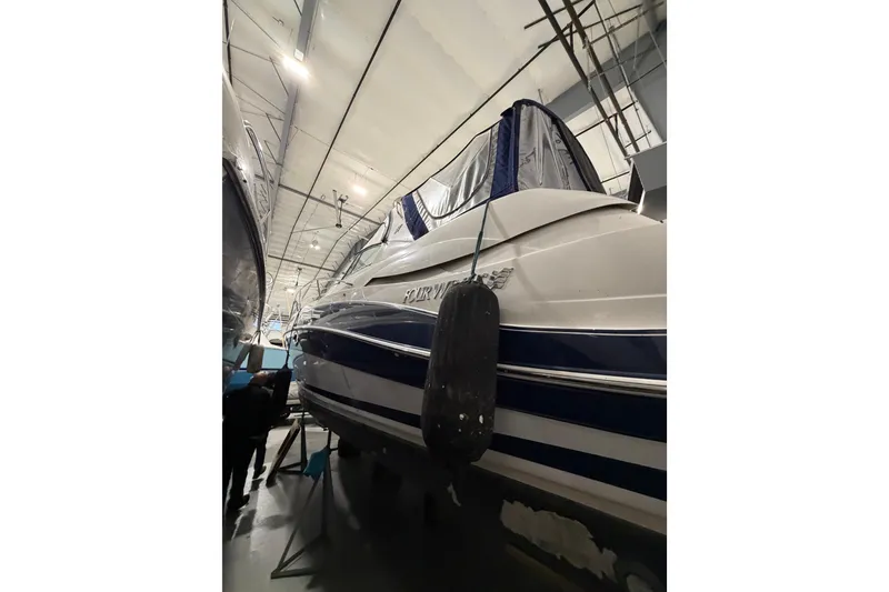Slide: The Image of 2007 Four Winns 338 Vista boat in indoor storage, side view with protective cover. - 4