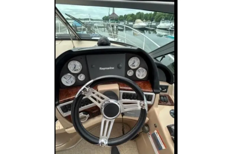 Slide: The Image of 2007 Four Winns 338 Vista boat dashboard with steering wheel and gauges. - 7
