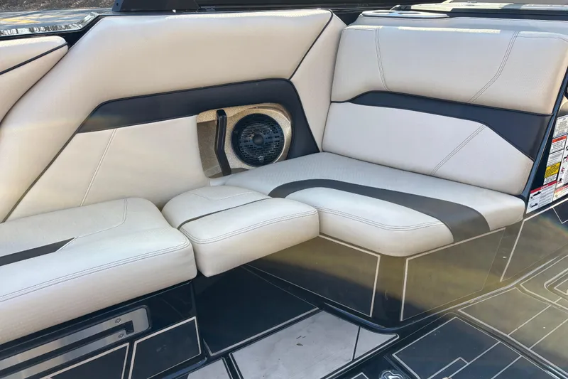 Slide: The Image of 2022 Centurion Ri265 boat interior with sleek, modern seating and integrated speaker system. - 11