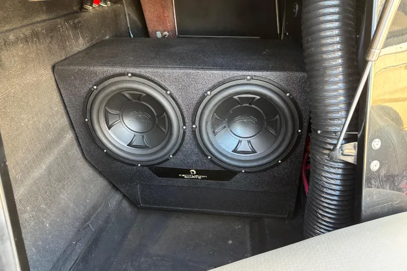 Slide: The Image of Dual subwoofer setup in a 2022 Centurion Ri265 boat interior. - 12