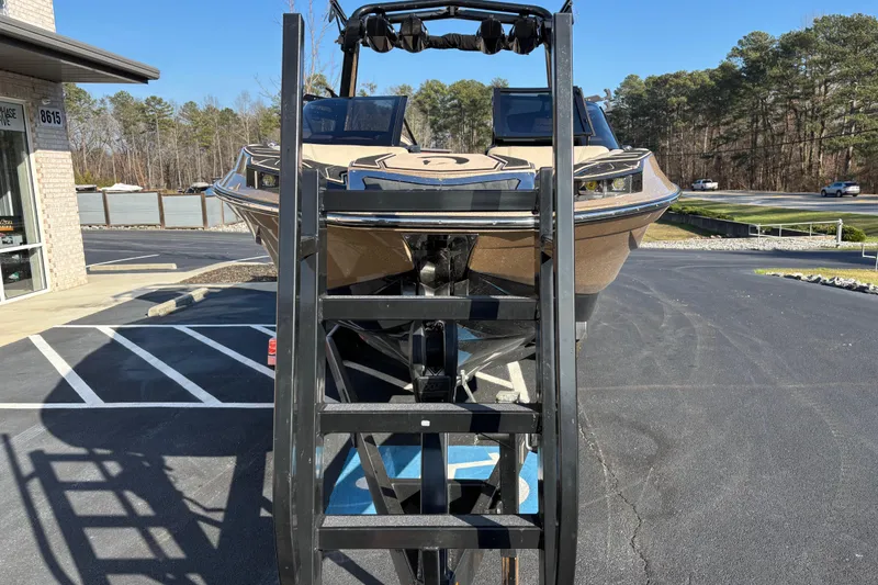 Slide: The Image of 2022 Centurion Ri265 boat on trailer in parking lot, front view. - 2