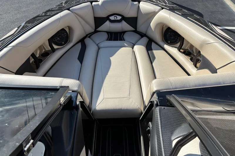 Slide: The Image of 2022 Centurion Ri265 boat interior with beige seating and built-in speakers. - 8