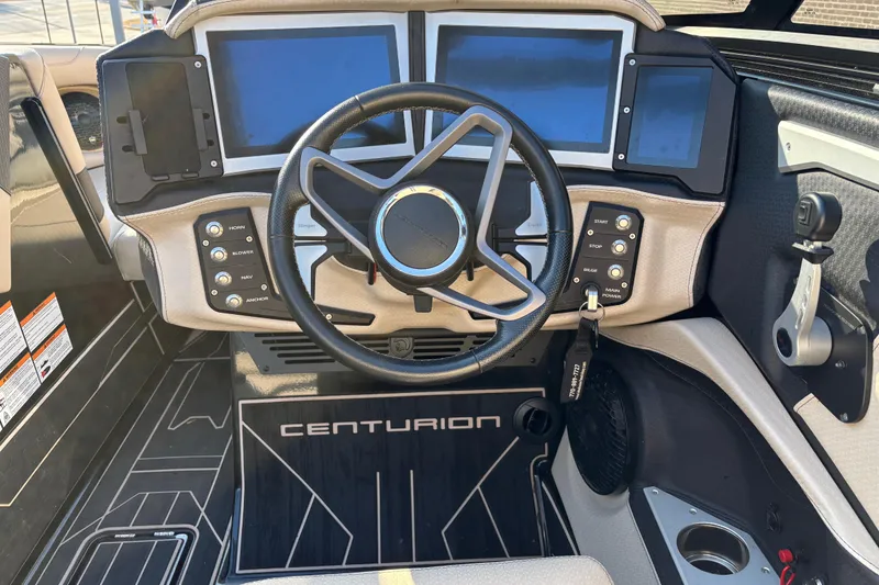 Slide: The Image of 2022 Centurion Ri265 boat dashboard with modern controls and steering wheel. - 9