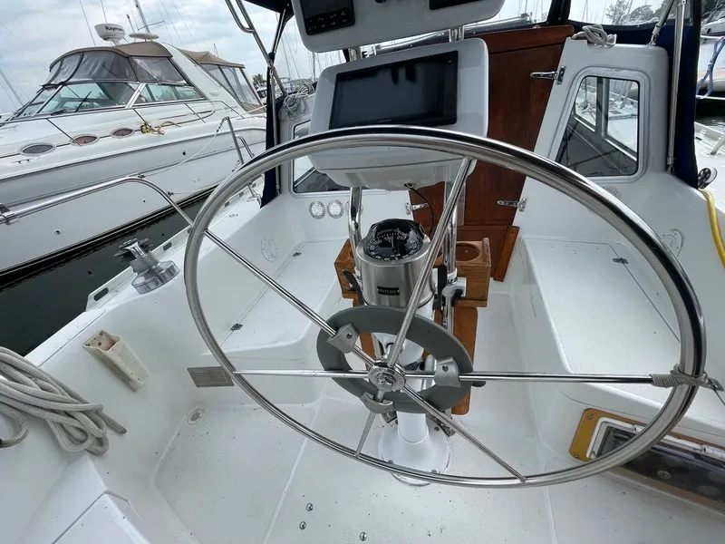 Slide: The Image of Steering wheel of 1977 Islander Yachts Freeport 36 in harbor. - 11