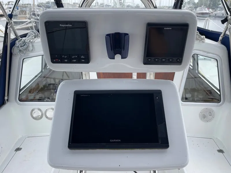 Slide: The Image of Islander Yachts Freeport 36 helm, 1977 model, featuring Raymarine and Garmin navigation systems. - 12