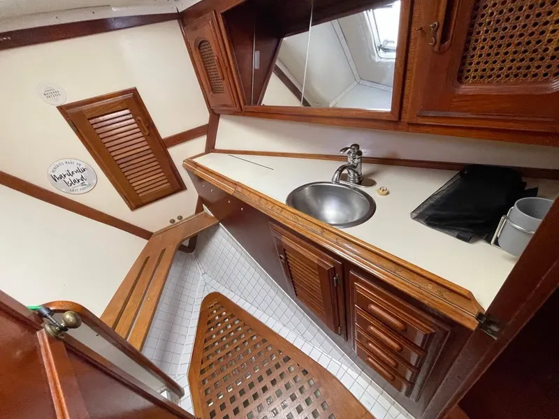 Slide: The Image of 1977 Islander Yachts Freeport 36 interior with wood finish and sink. - 9