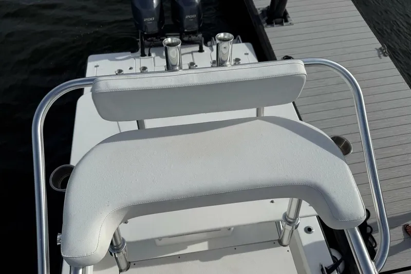 Slide: The Image of 2023 T Craft 27 boat with white seating and dual outboard motors. - 10