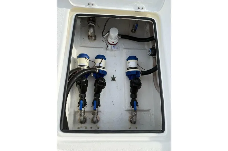 Slide: The Image of Bilge compartment of 2023 T Craft 27 boat with pumps and hoses. - 13