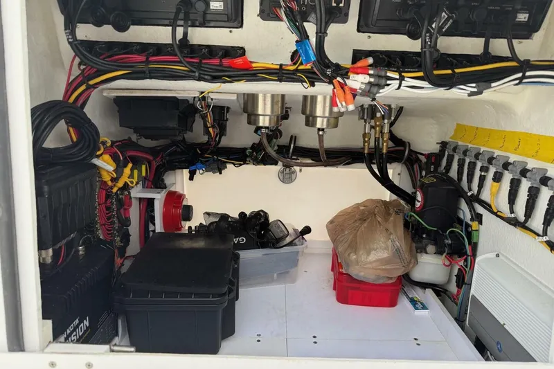 Slide: The Image of Interior view of a 2023 T Craft 27 boat showing organized wiring and equipment. - 15