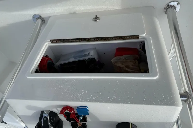 Slide: The Image of Storage compartment on a 2023 T Craft 27 boat, featuring a sleek white design. - 18
