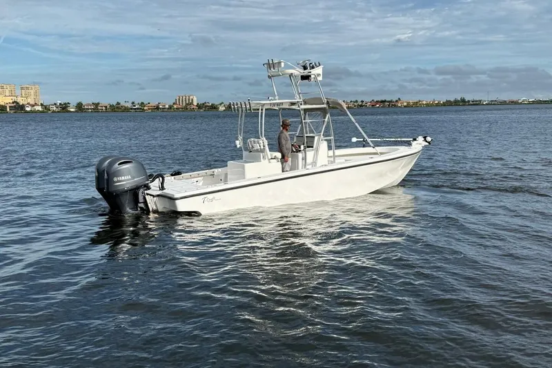 Slide: The Image of 2023 T Craft 27 boat on calm water with Yamaha outboard motor. - 24