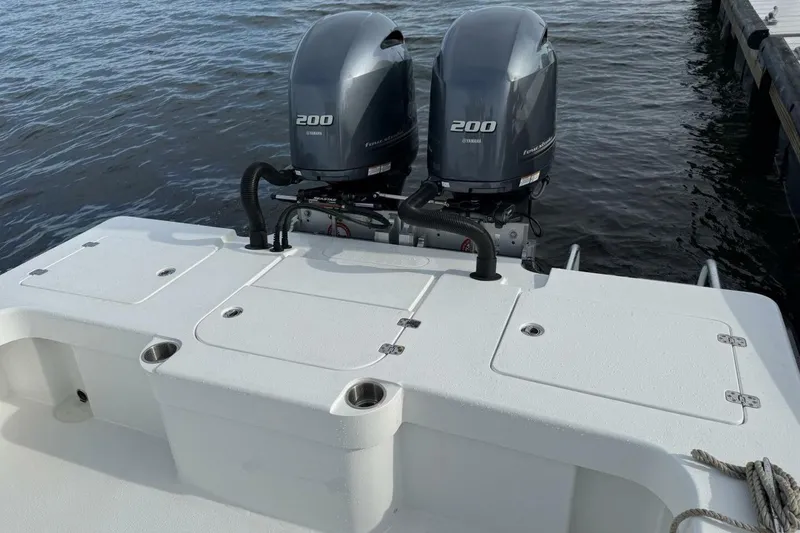 Slide: The Image of 2023 T Craft 27 boat with dual Yamaha 200 engines docked on water. - 3