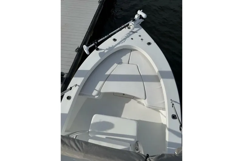 Slide: The Image of 2023 T Craft 27 boat bow with seating and trolling motor at dock. - 8