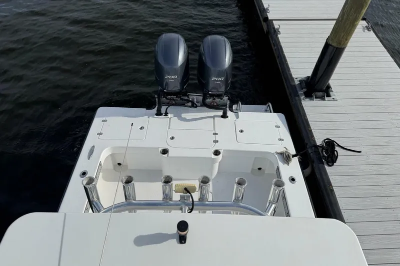 Slide: The Image of 2023 T Craft 27 boat with dual 200 horsepower engines docked at a marina. - 9