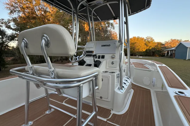 Slide: The Image of 2011 Hydra-Sports Bay Bolt 23 boat interior with helm, seating, and wood accents. - 14