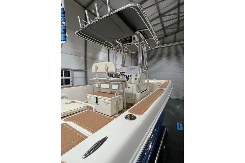 Slide: The Image of 2011 Hydra-Sports Bay Bolt 23 boat interior with T-top and seating in a garage. - 19