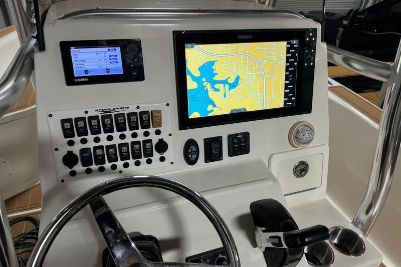 Slide: The Image of 2011 Hydra-Sports Bay Bolt 23 dashboard with navigation and control panels. - 22
