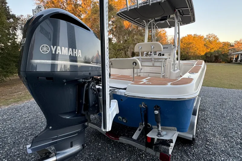 Slide: The Image of 2011 Hydra-Sports Bay Bolt 23 boat with Yamaha outboard motor, parked on gravel. - 6