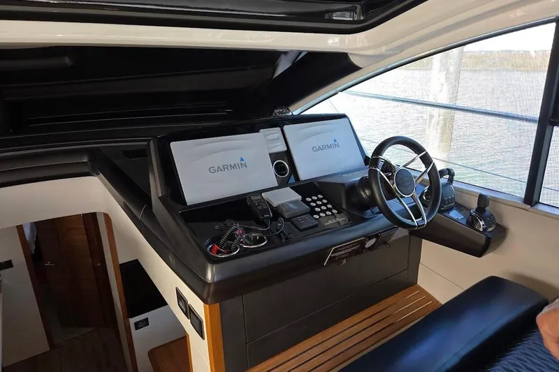 Slide: The Image of 2019 Sunseeker Predator 50 yacht helm with Garmin navigation system and steering wheel. - 13