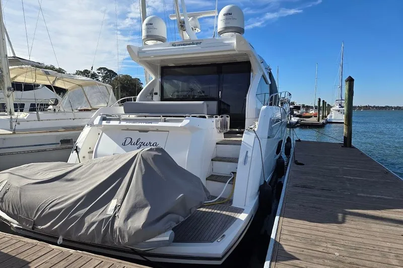 Slide: The Image of 2019 Sunseeker Predator 50 yacht docked at marina, rear view. - 2