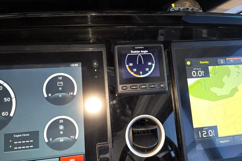 Slide: The Image of Control panel of 2019 Sunseeker Predator 50 yacht with digital displays and navigation instruments. - 20