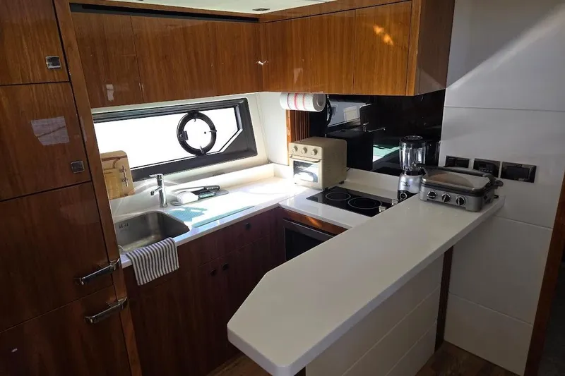 Slide: The Image of Interior of 2019 Sunseeker Predator 50 yacht with cozy seating and wooden table. - 23