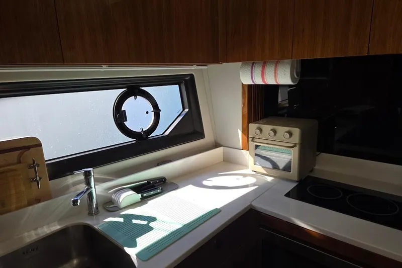 Slide: The Image of Interior of 2019 Sunseeker Predator 50 yacht with white seating and colorful cushions. - 24