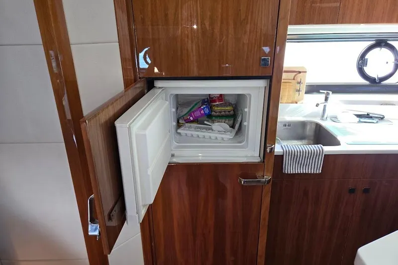 Slide: The Image of Modern kitchen interior of 2019 Sunseeker Predator 50 yacht with appliances and window. - 29