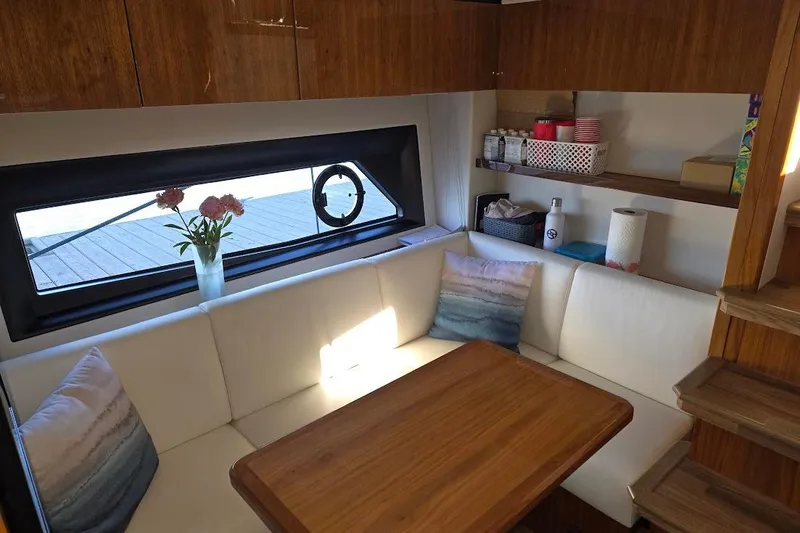 Slide: The Image of Luxurious interior of 2019 Sunseeker Predator 50 yacht with cozy seating and wooden table. - 4