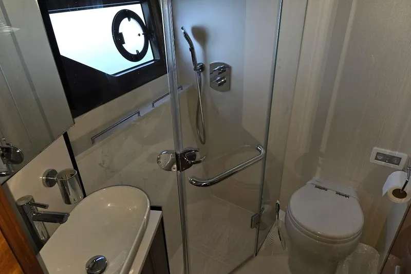 Slide: The Image of Luxurious bathroom in 2019 Sunseeker Predator 50 yacht with modern sink and wooden cabinetry. - 46