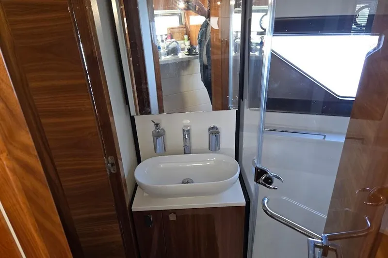 Slide: The Image of Luxurious bathroom sink in 2019 Sunseeker Predator 50 yacht with wooden cabinetry. - 47