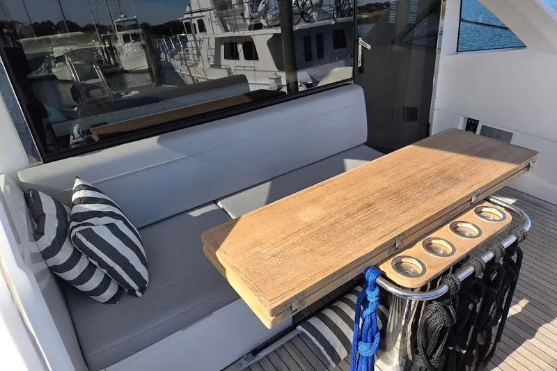 Slide: The Image of 2019 Sunseeker Predator 50 yacht docked, showcasing sleek design and luxury features. - 55