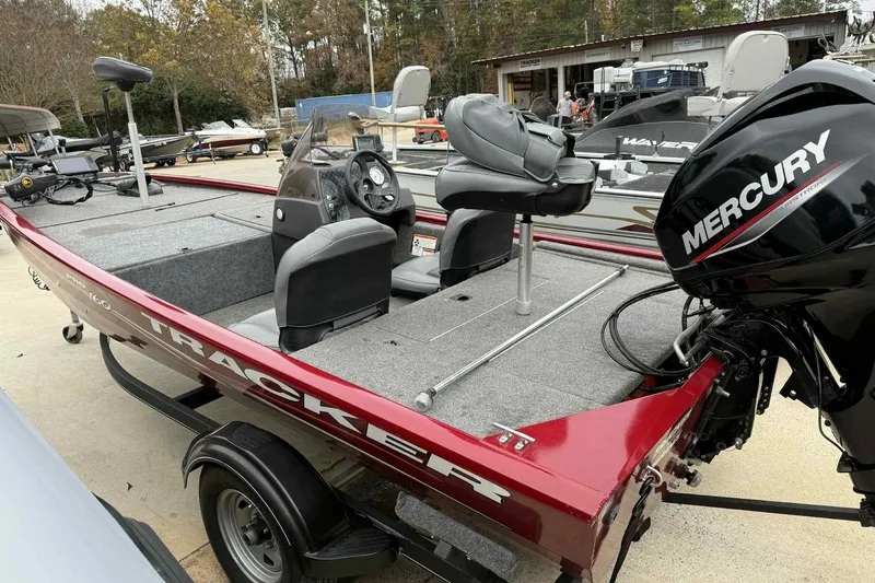 Slide: The Image of 2020 Bass Tracker PT 160 boat with Mercury engine, parked outdoors. - 8
