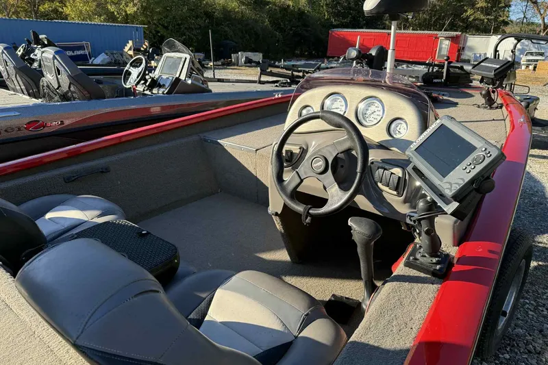 Slide: The Image of 2006 Bass Tracker PT190 boat interior with steering wheel and navigation equipment. - 6