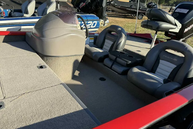 Slide: The Image of 2006 Bass Tracker PT190 boat interior with gray seats and steering console. - 7