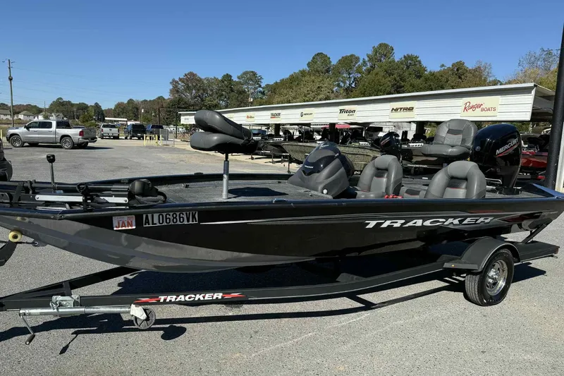 Slide: The Image of 2021 Bass Tracker 190 PT boat on trailer, parked outdoors, with visible Mercury engine. - 3