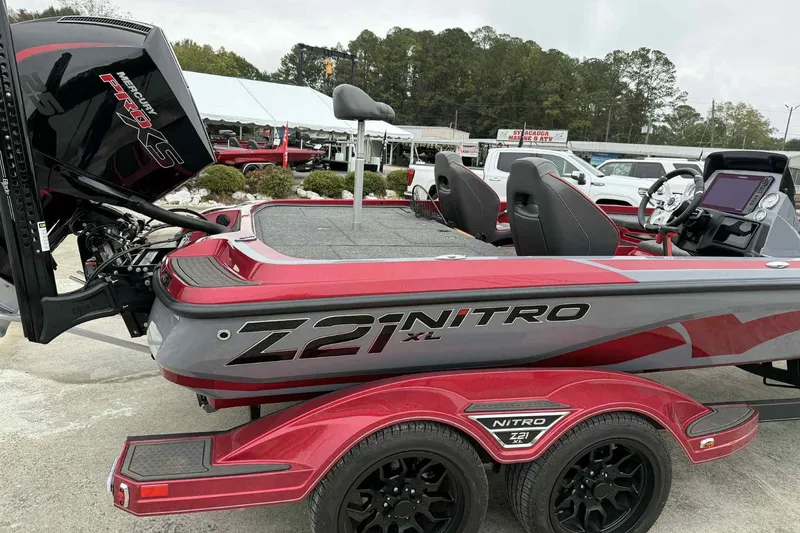 Slide: The Image of 2024 Nitro Z21 XL boat with Mercury Pro XS engine, red and gray design. - 2